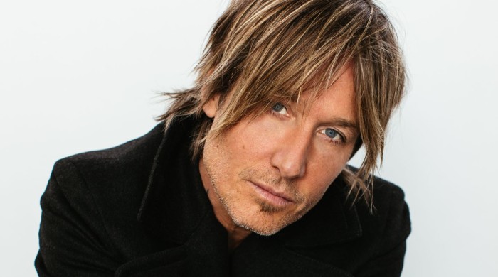 A close up image of Keith Urban wearing a black jacket